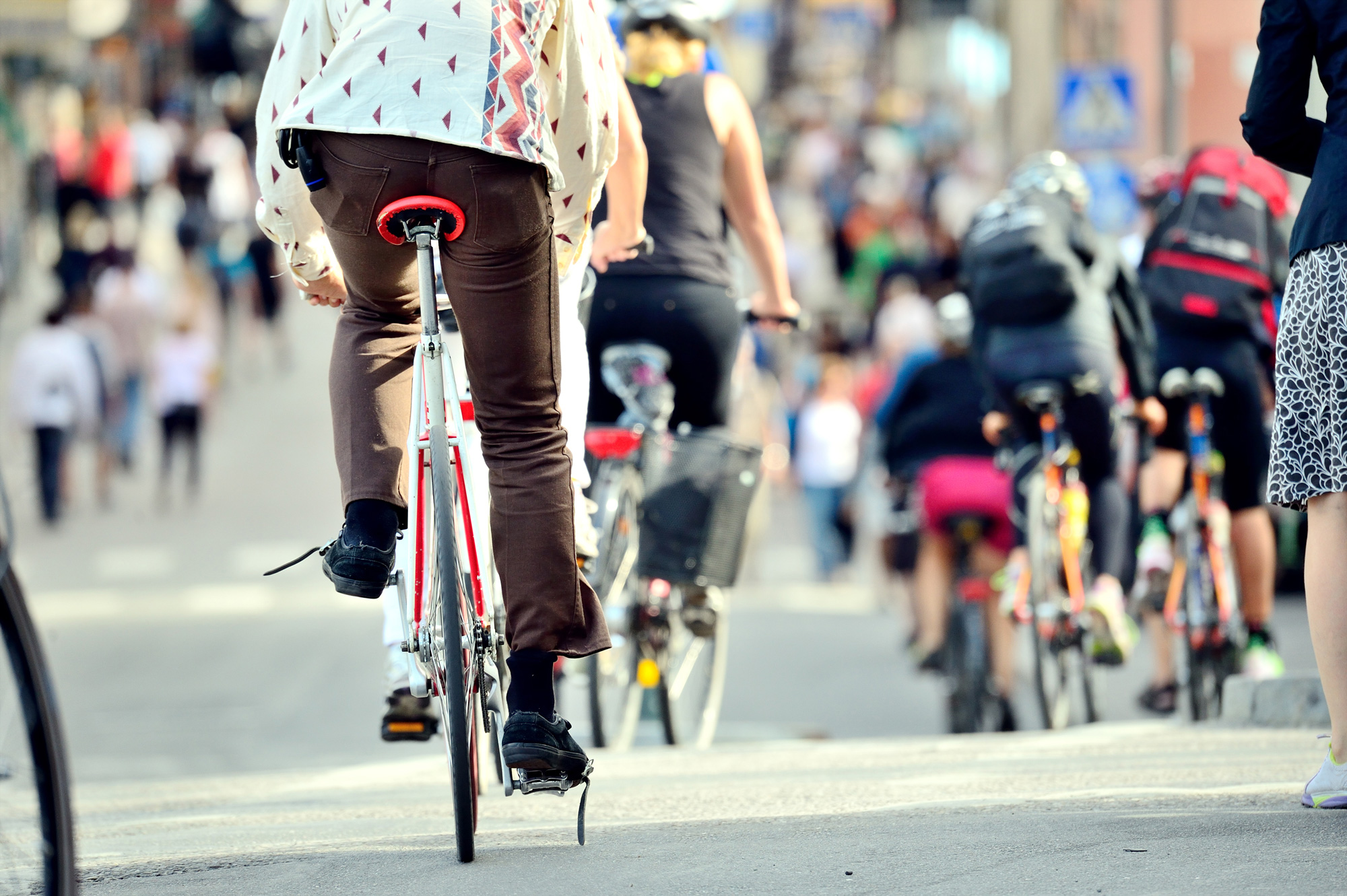 People riding bikes through city